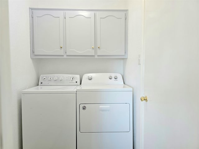 laundry area with cabinets and separate washer and dryer