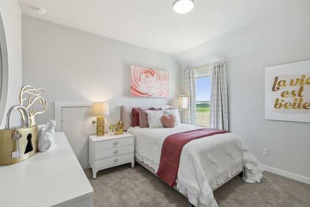 bedroom with light colored carpet and lofted ceiling