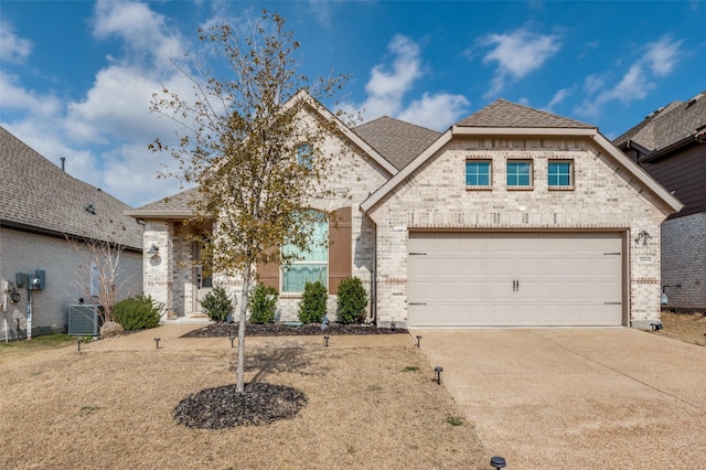 view of front of property with central AC and a garage