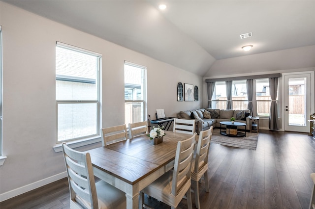 dining room with vaulted ceiling and dark hardwood / wood-style floors