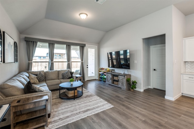 living room featuring hardwood / wood-style flooring and vaulted ceiling