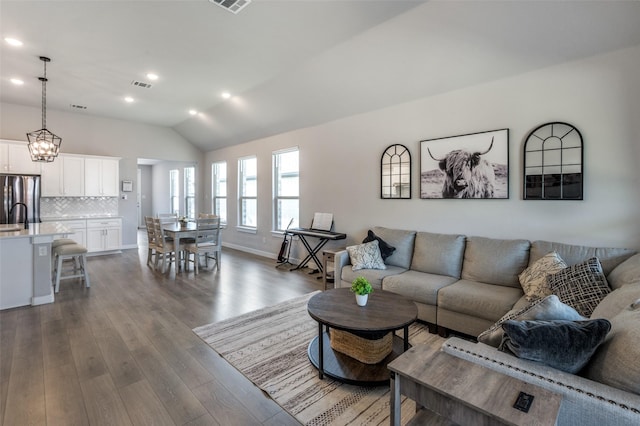 living room featuring dark hardwood / wood-style flooring and lofted ceiling