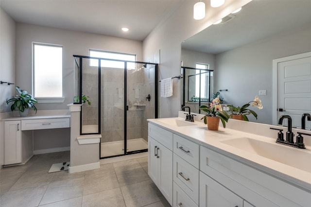 bathroom featuring vanity, tile patterned flooring, and a shower with door