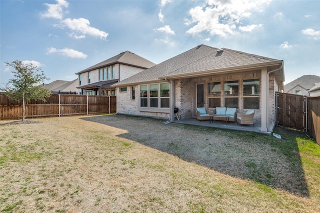 rear view of property with an outdoor living space, a patio, and a lawn