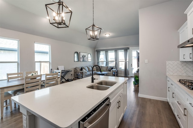 kitchen with sink, white cabinetry, hanging light fixtures, stainless steel appliances, and a center island with sink