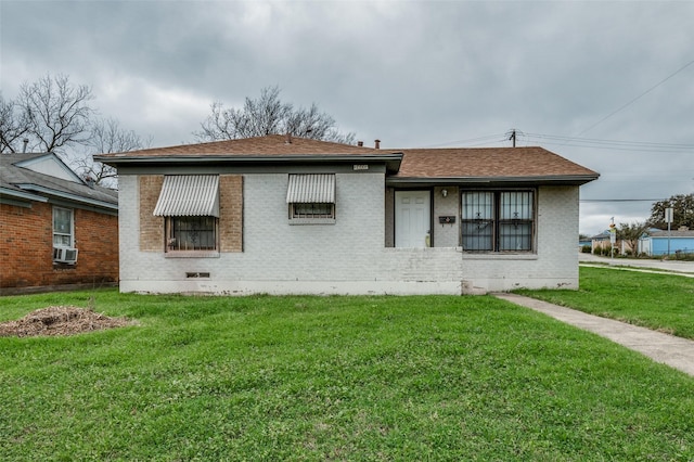 rear view of property featuring a yard and cooling unit