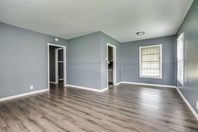 empty room with hardwood / wood-style flooring