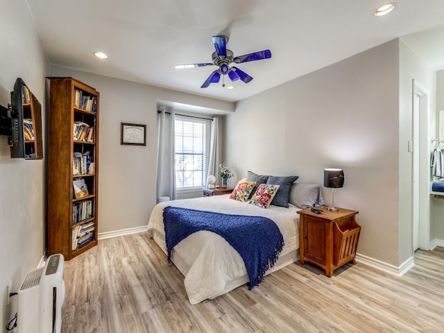 bedroom with recessed lighting, light wood-style flooring, and baseboards