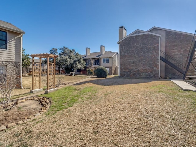 view of yard featuring stairway and a pergola