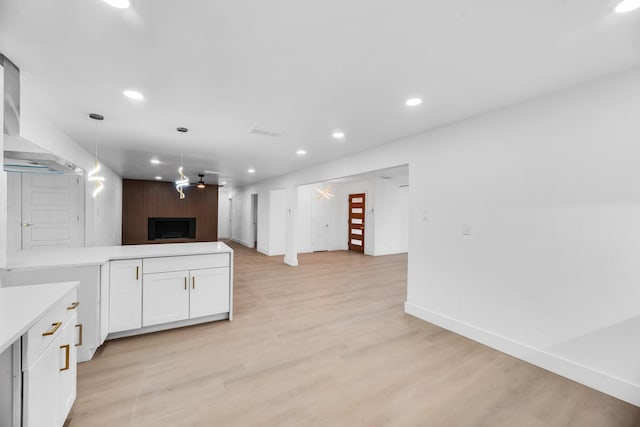 kitchen featuring white cabinetry, ceiling fan, light hardwood / wood-style floors, and decorative light fixtures