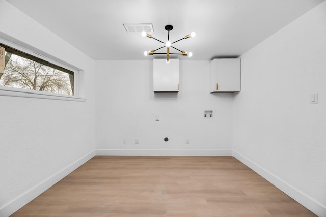 laundry room with electric dryer hookup, washer hookup, a notable chandelier, and light wood-type flooring