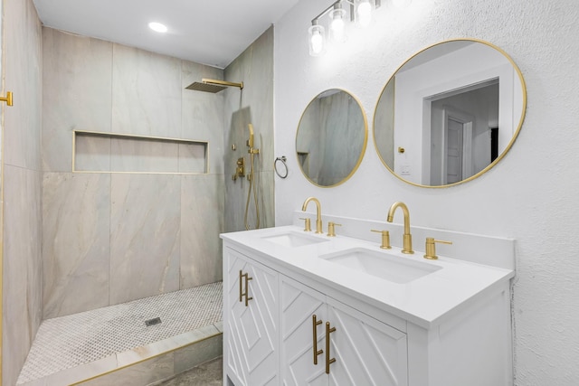 bathroom with vanity and a tile shower