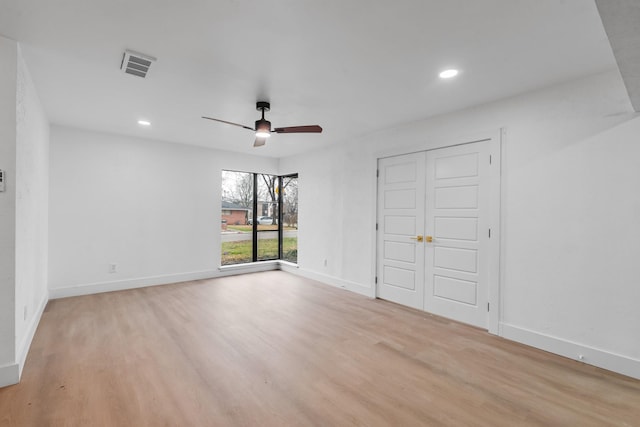 unfurnished room with ceiling fan and light wood-type flooring