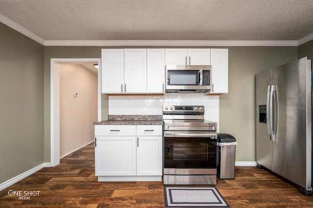 kitchen featuring white cabinetry, appliances with stainless steel finishes, and dark wood-type flooring
