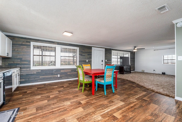 dining room featuring ceiling fan, dark hardwood / wood-style floors, and a textured ceiling