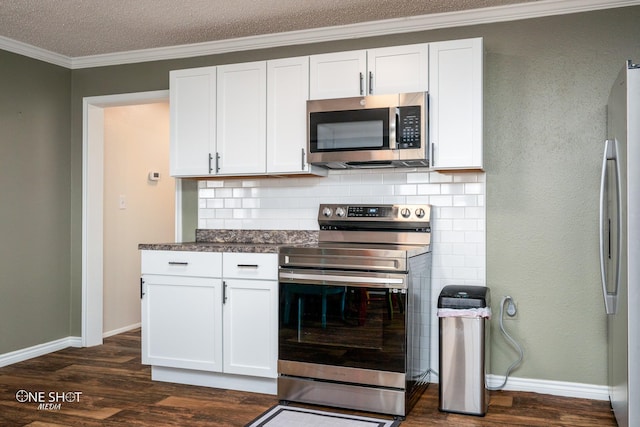 kitchen with tasteful backsplash, white cabinetry, dark hardwood / wood-style flooring, stainless steel appliances, and crown molding