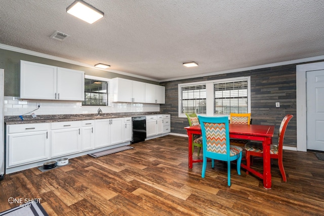 kitchen featuring ornamental molding, dark hardwood / wood-style flooring, dishwasher, and white cabinets