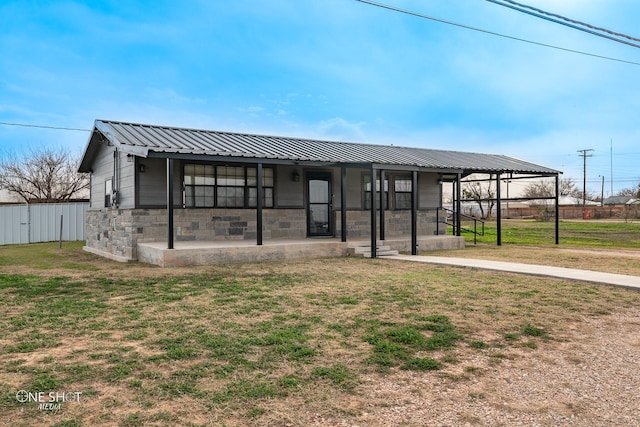 view of front of property with a front yard and covered porch