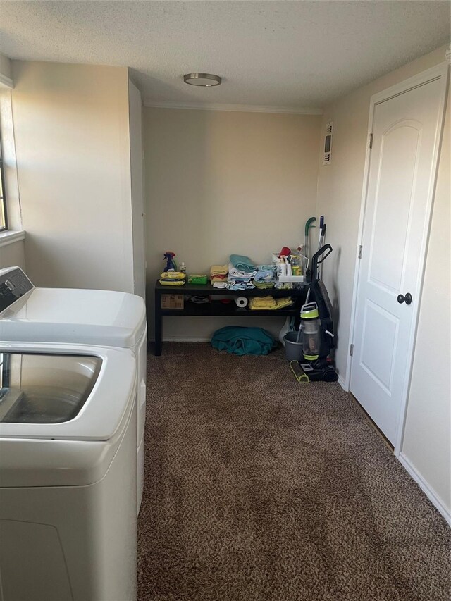laundry room with dark carpet, independent washer and dryer, and a textured ceiling