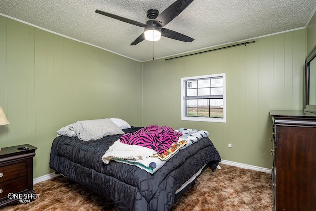 bedroom featuring crown molding, ceiling fan, a textured ceiling, and dark colored carpet
