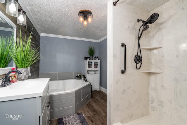 bathroom featuring vanity, hardwood / wood-style floors, crown molding, and a textured ceiling