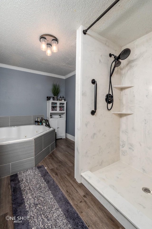 bathroom with hardwood / wood-style flooring, crown molding, independent shower and bath, and a textured ceiling