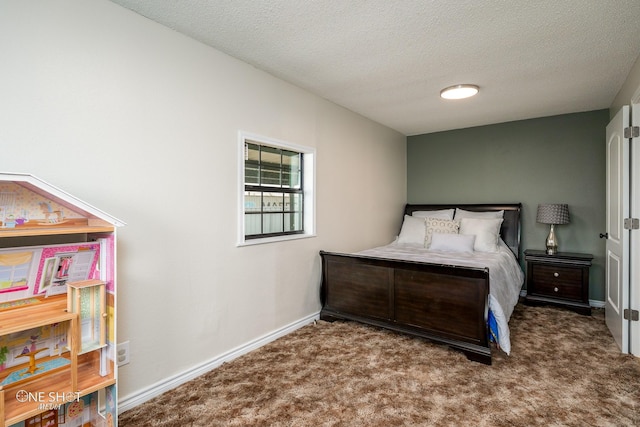 bedroom with carpet floors and a textured ceiling