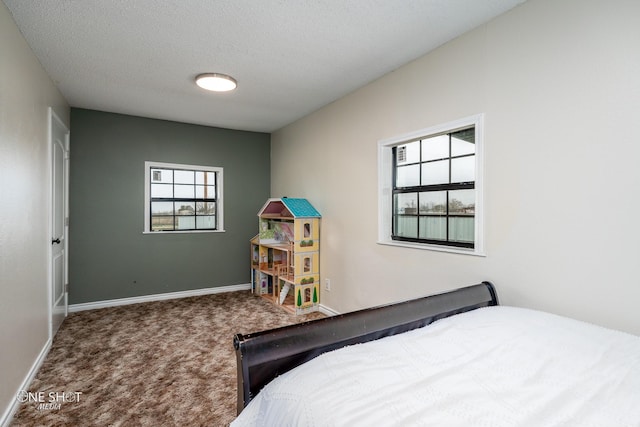 carpeted bedroom with a textured ceiling