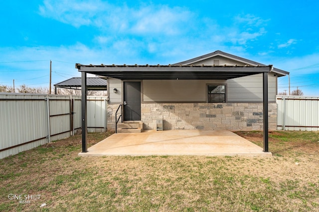 back of house with a lawn