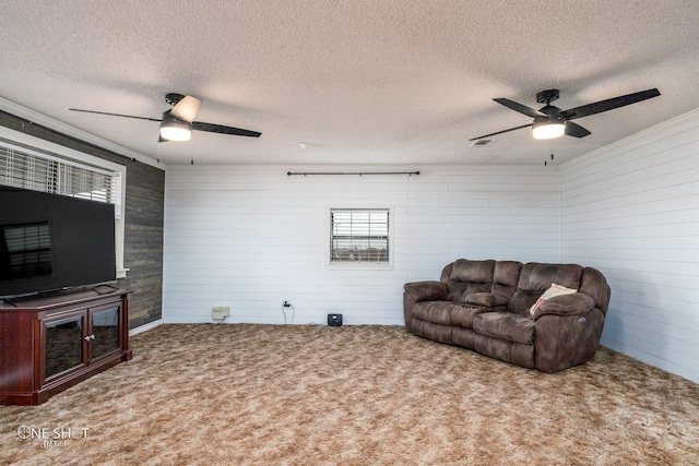 living room with carpet, a textured ceiling, and ceiling fan