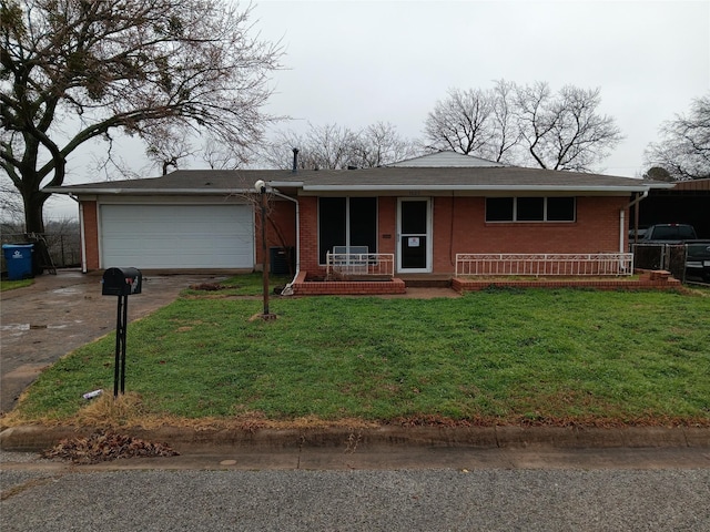 single story home featuring a garage, a front yard, and covered porch