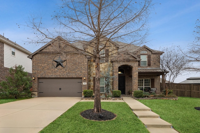 traditional-style house with a garage, concrete driveway, fence, a front yard, and brick siding