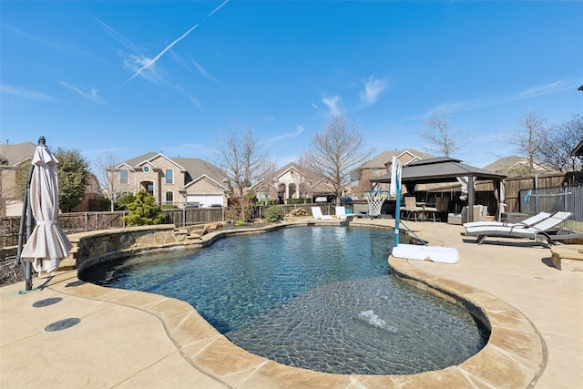 view of pool with a fenced backyard, a patio, a fenced in pool, and a gazebo