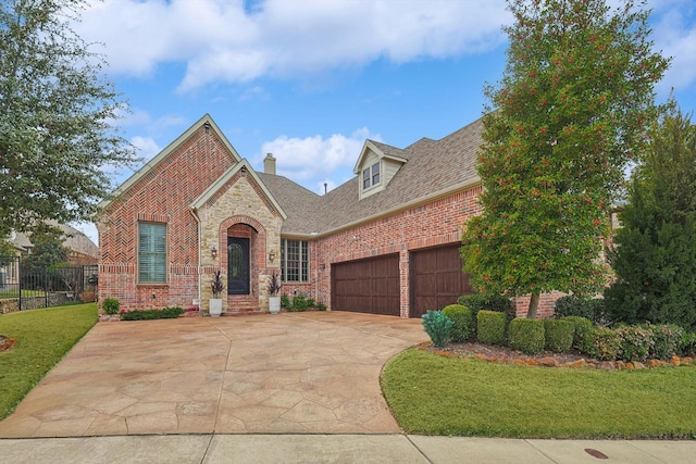 view of front of home featuring a garage and a front yard