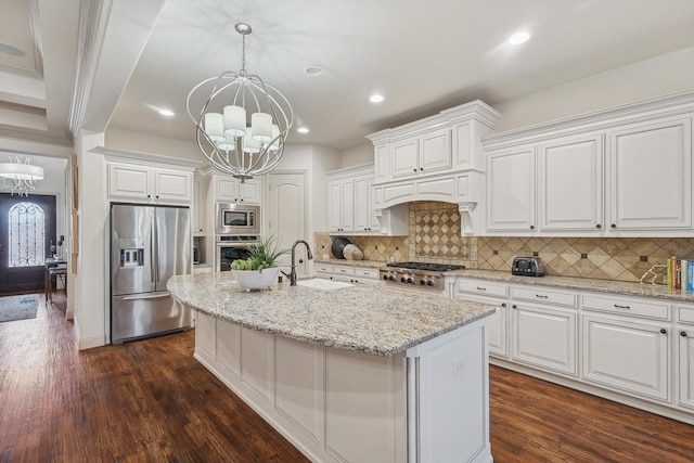 kitchen with white cabinetry, stainless steel appliances, a chandelier, and sink