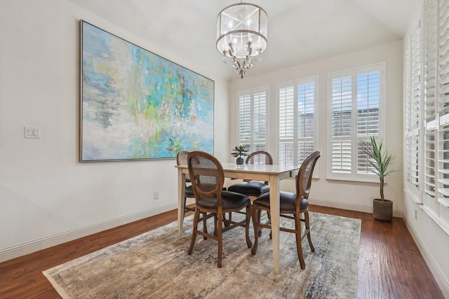 dining room featuring dark hardwood / wood-style flooring and a notable chandelier