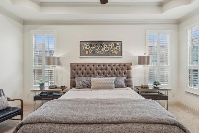 carpeted bedroom featuring crown molding and a tray ceiling