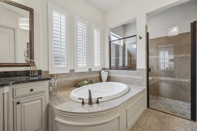 bathroom with independent shower and bath, vanity, and tile patterned floors