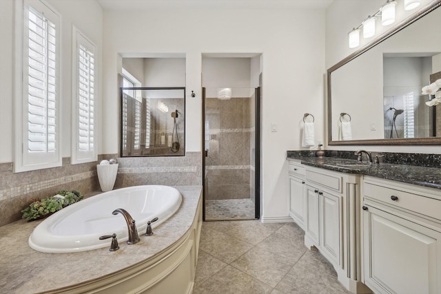 bathroom featuring vanity, shower with separate bathtub, and tile patterned flooring