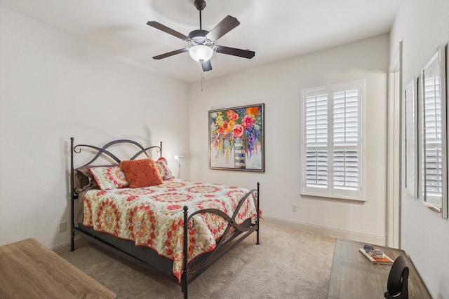 bedroom featuring ceiling fan and light carpet