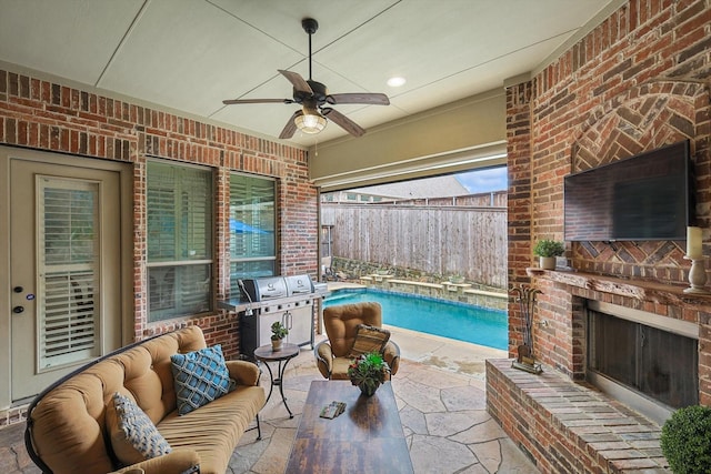 view of patio with ceiling fan, an outdoor living space with a fireplace, a fenced in pool, and area for grilling