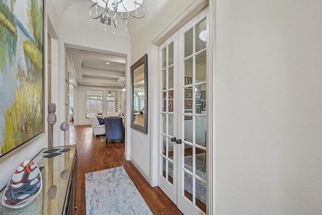 doorway featuring french doors, dark hardwood / wood-style flooring, and a chandelier