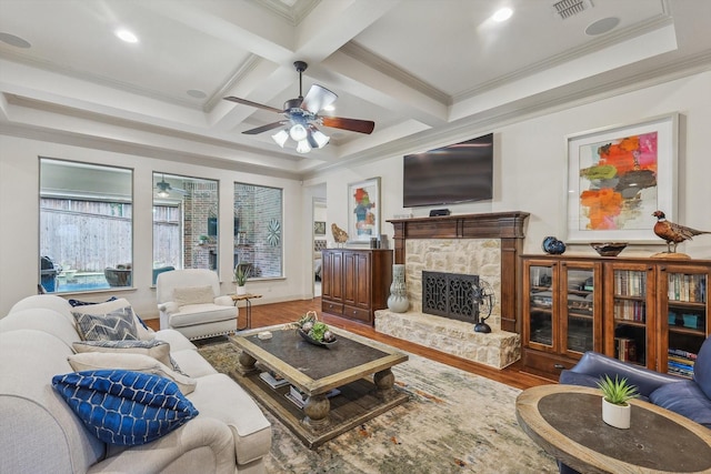 living room with coffered ceiling, beam ceiling, ornamental molding, hardwood / wood-style flooring, and a fireplace