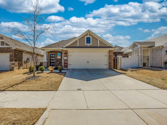 view of front of property featuring concrete driveway, brick siding, fence, and an attached garage