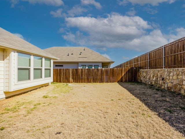 view of yard with a fenced backyard