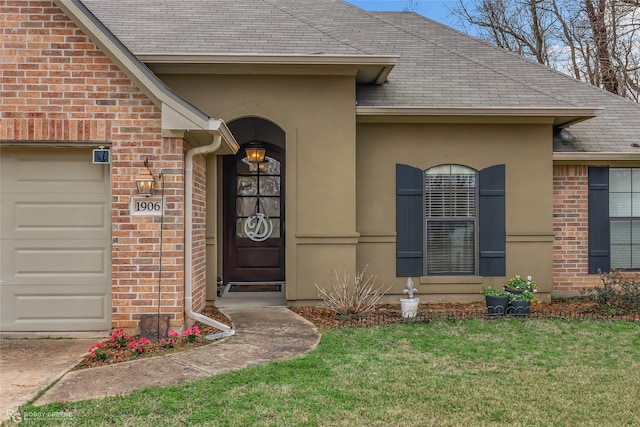 property entrance featuring a garage and a yard