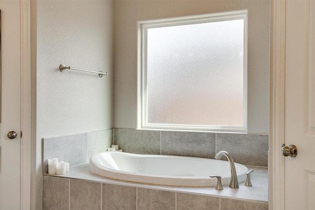 bathroom with tiled tub