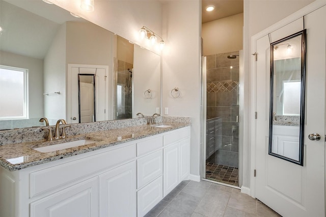 bathroom featuring lofted ceiling, vanity, a shower with door, and tile patterned floors