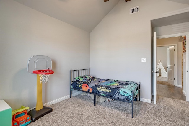 bedroom with carpet floors and vaulted ceiling