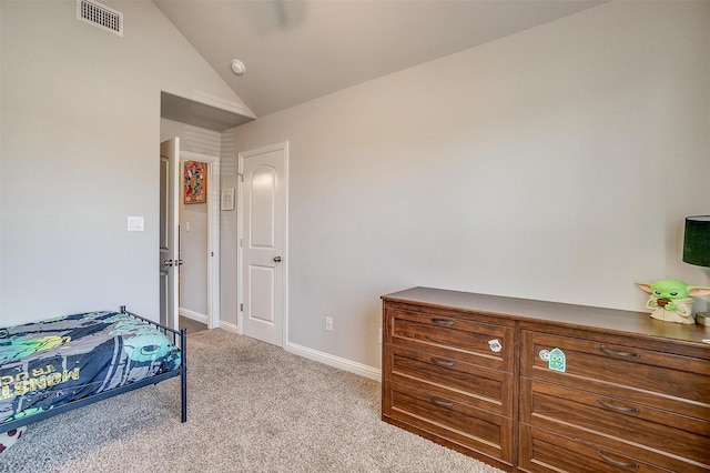 bedroom with lofted ceiling and light carpet